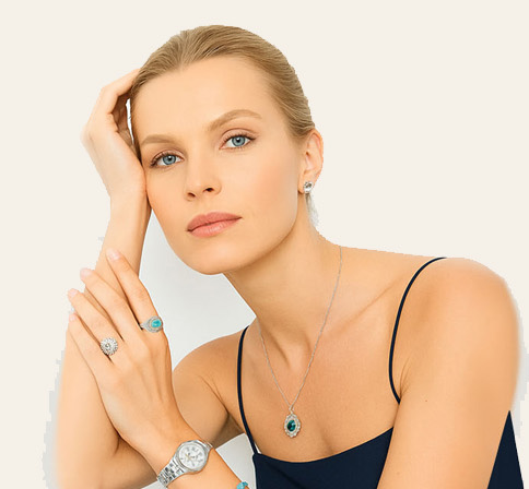 Model wearing emerald and diamond fine jewelry